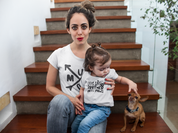 pretty mom and her baby girl wearing different t shirts mockup while in wooden stairways with a dog 16087